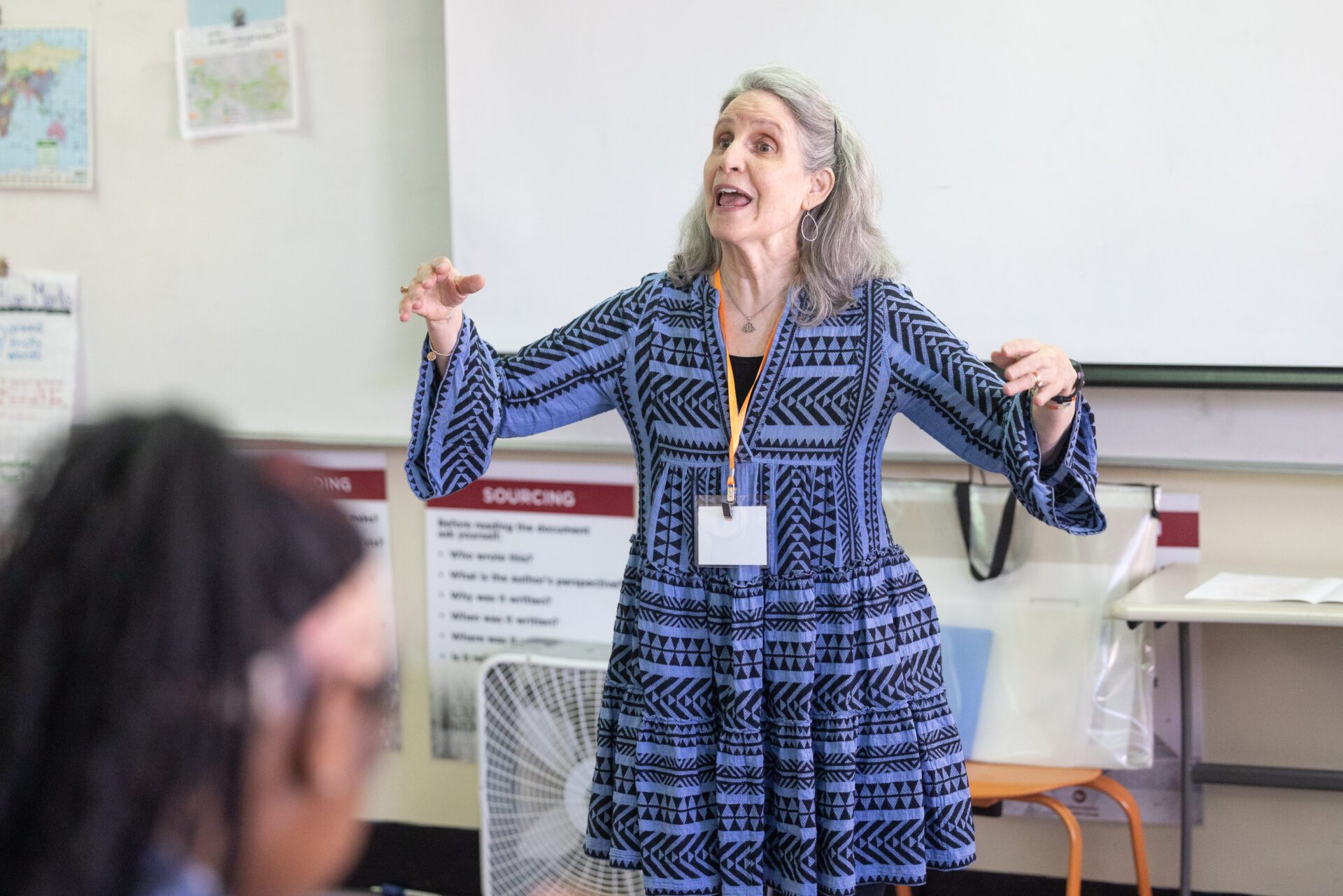 BLSYW Cool Women Hot Jobs 2024-129 Teacher in patterned dress gesturing during a class.